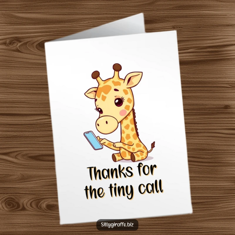 Funny Free Printable Thank You Card: A giraffe looking bewildered while trying to operate a ridiculously small mobile phone.